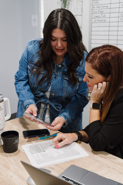 Reviewing marketing materials together at a desk